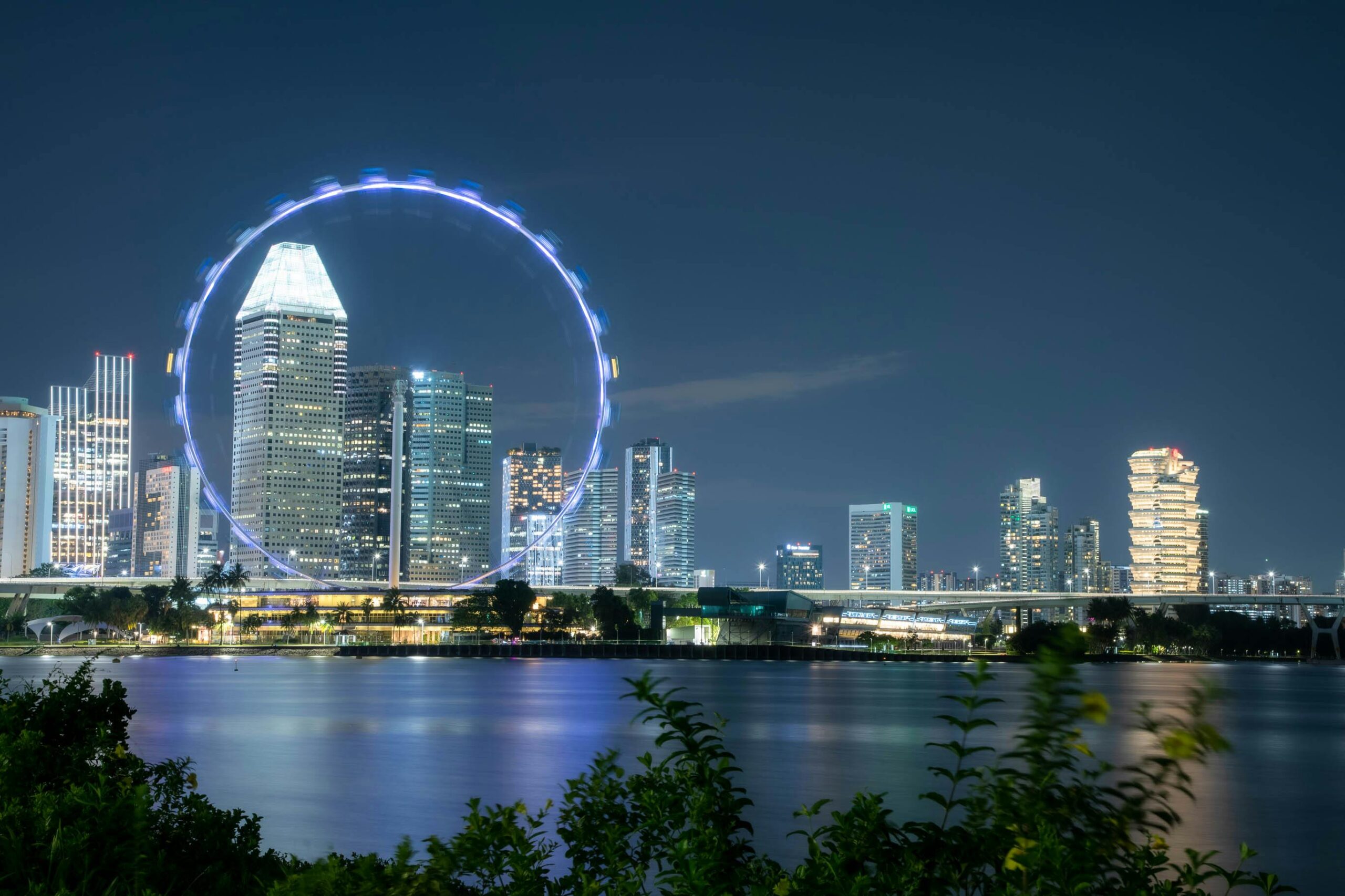Vibrant Singapore skyline with Marina Bay Sands, Gardens by the Bay Supertrees, and city lights at dusk - top places to visit for travelers and tourists