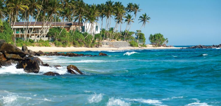 Luxury beachfront wedding venue at a destination wedding hotel in Bentota, Sri Lanka with palm trees and ocean view