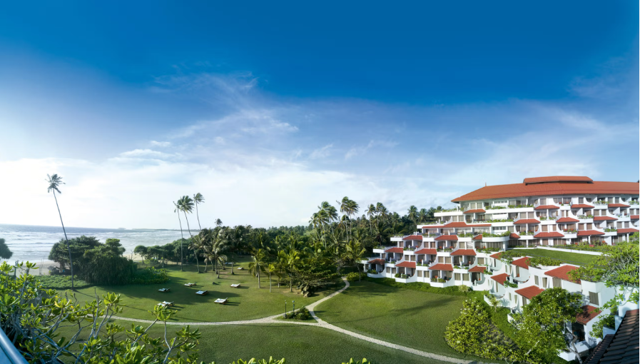 Bentota in sri lanka Luxury hillside resort with landscaped gardens and ocean view under blue sky