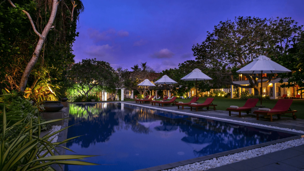Sri Lanka Luxury resort pool at night with illuminated villas and tropical landscape
