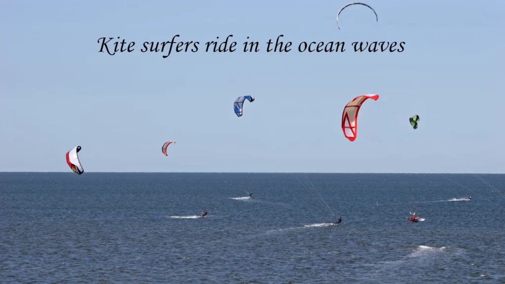 Kitesurfers riding ocean waves during a water sports activity in Bentota, Sri Lanka