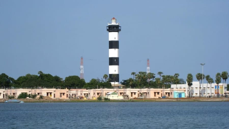 Tall black and white Pulicat Lighthouse near Pazhaverkadu beach and Pulicat Lake in Tamil Nadu.