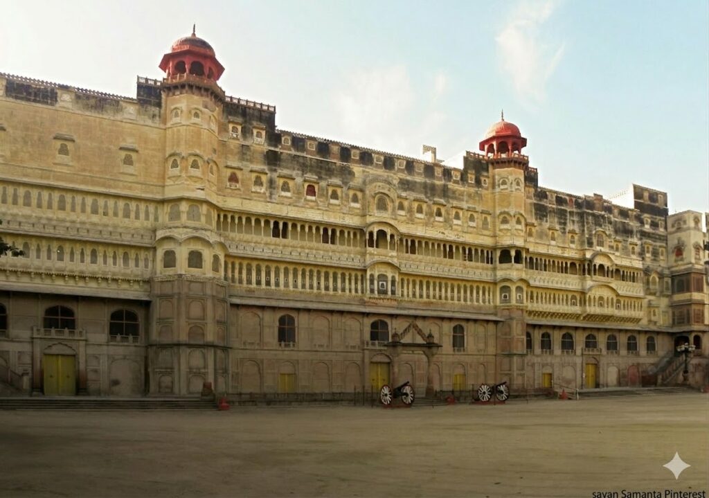 Forts and Palaces of India: The expansive stone facade and courtyard of Junagarh Fort in Bikaner, featuring intricate Rajput architecture, red-domed chhatris, and vintage cannons on the grounds.