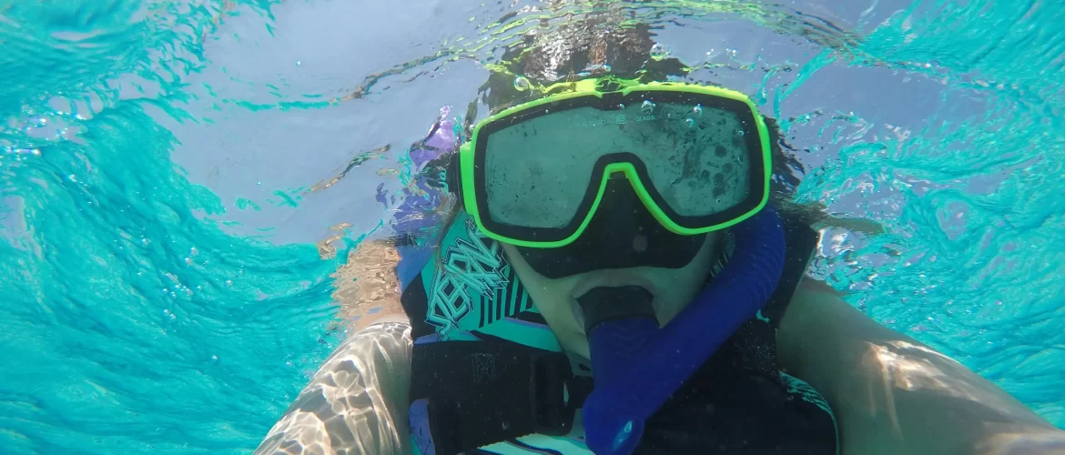 Scuba diver exploring coral reef with sea turtle in Hikkaduwa, Sri Lanka