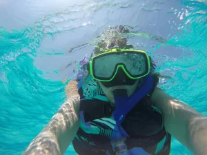 Scuba diving exploring coral reef with sea turtle in Hikkaduwa, Sri Lanka