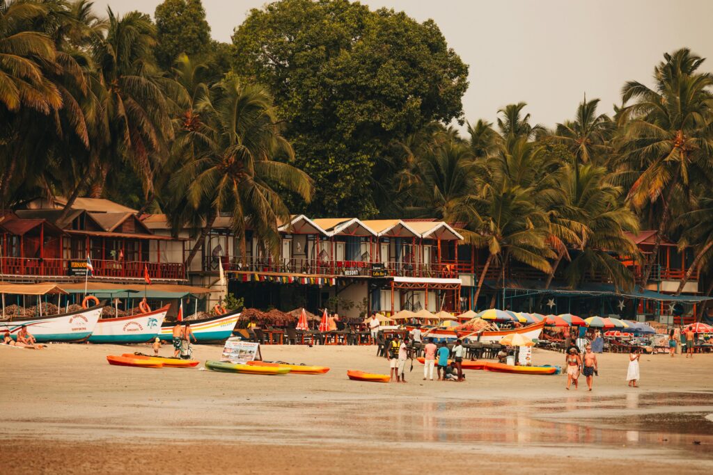Beautiful beach view in Goa with golden sand, blue sea, and palm trees