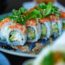 Assortment of popular Japanese foods including sushi, tempura, ramen, and traditional dishes