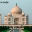 The majestic Taj Mahal in India surrounded by tourists, an essential destination to include when planning your travel itinerary for a historic vacation.