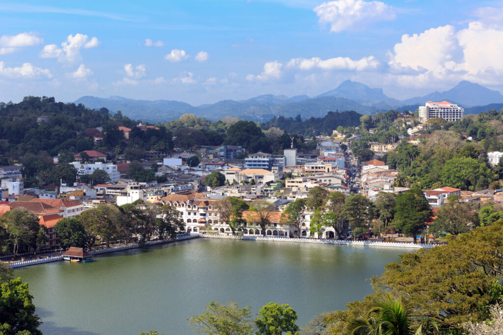 Kandy Town Sri Lanka UNESCO Heritage Sites — panoramic view of the sacred city with Kandy Lake, Temple of the Tooth Relic and misty hill ranges in the background