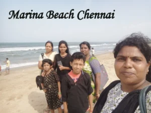 Family enjoying a day at Marina Beach in Chennai with the sea and sandy shoreline in the background