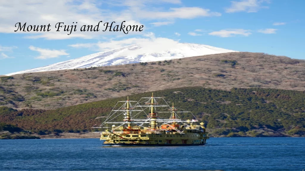 The iconic Lake Ashi pirate cruise boat sailing on blue water with a snow-capped Mount Fuji in the background during a 7 days tour in Japan.