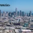 An aerial panoramic view of the San Francisco skyline showcasing downtown skyscrapers and the bay, highlighting iconic cities to visit in America.