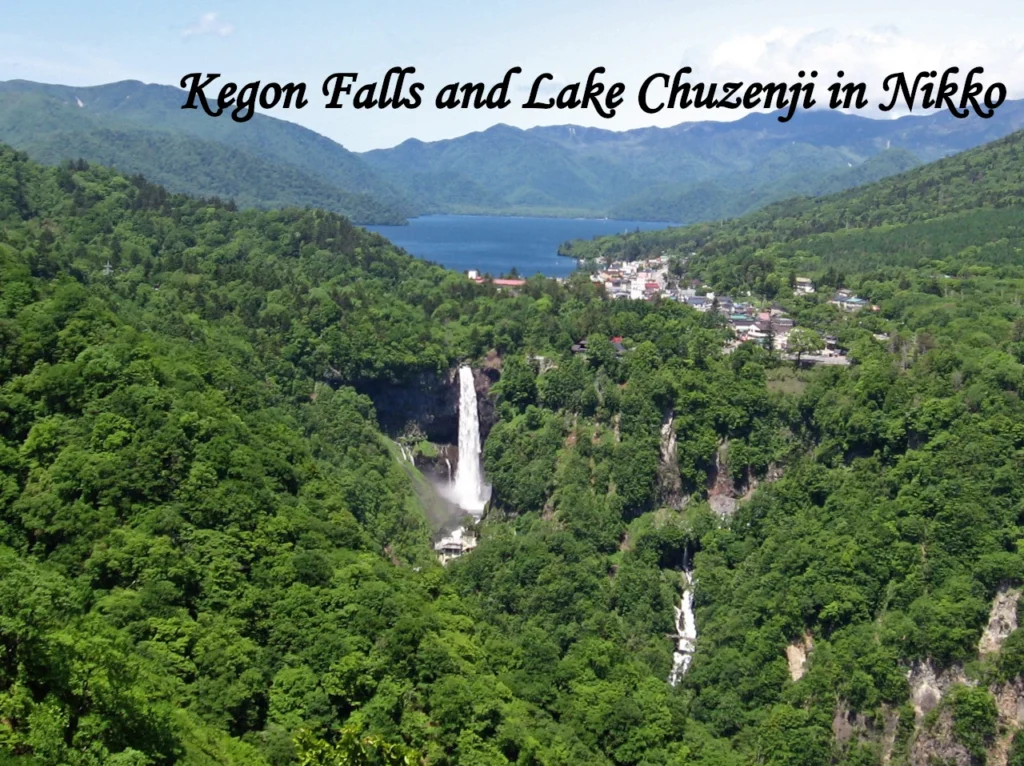 A high waterfall surrounded by lush green mountains and a deep blue lake, representing scenic day trips to consider when comparing Tokyo vs Osaka.
