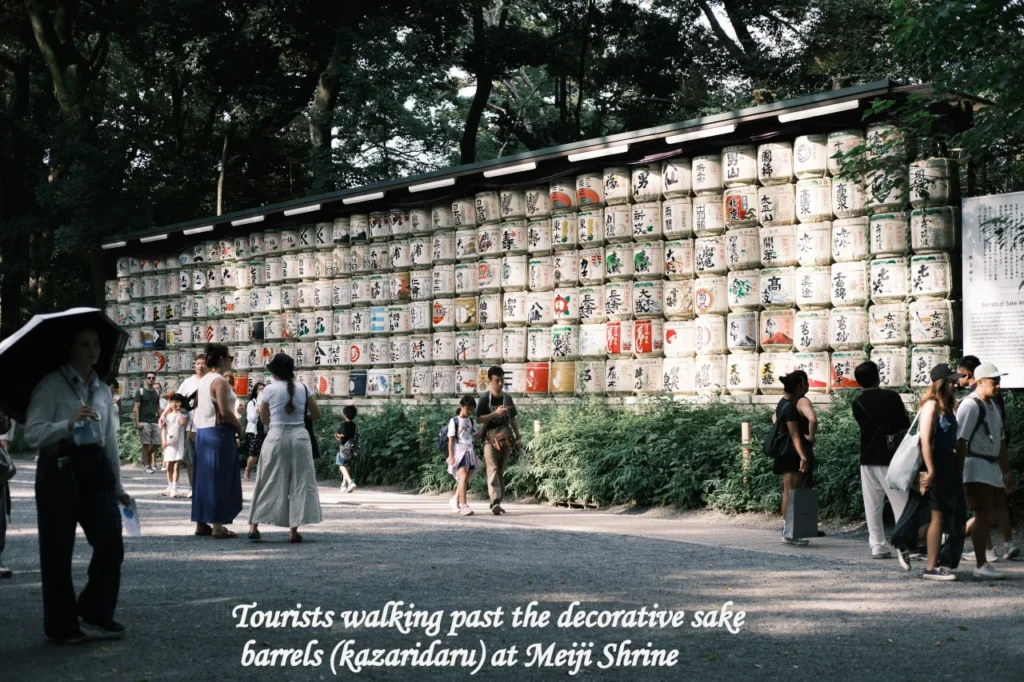 A large wall of colorful, traditional sake barrels at Meiji Jingu Shrine in Tokyo, featured in a Tokyo vs Osaka travel comparison blog post - Tokyo vs Osaka