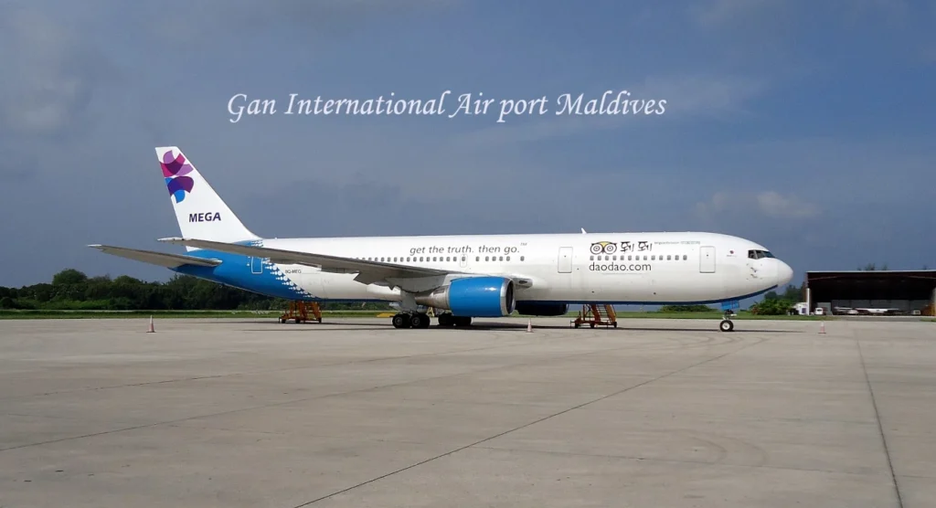Gan International Airport in Addu Atoll, Maldives with airport terminal and aircraft