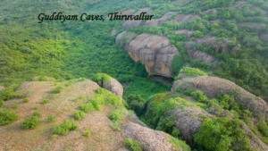 Gudiyam Caves in Tiruvallur surrounded by lush green forest and rocky hills