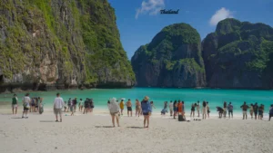 Thailand Tourist Places 2026 featuring a beautiful tropical beach with turquoise water and limestone cliffs