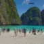 Thailand Tourist Places 2026 featuring a beautiful tropical beach with turquoise water and limestone cliffs