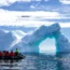 Antarctica tourism 2026 Antarctica glacier arch with tourists exploring by boat