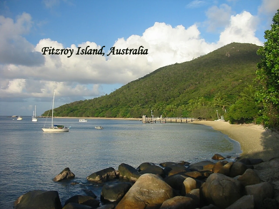 Fitzroy Island Australia with tropical rainforest, calm waters and rocky shoreline