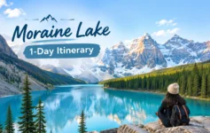 Vibrant turquoise waters of Moraine Lake framed by the towering snow-covered peaks of the Canadian Rockies.