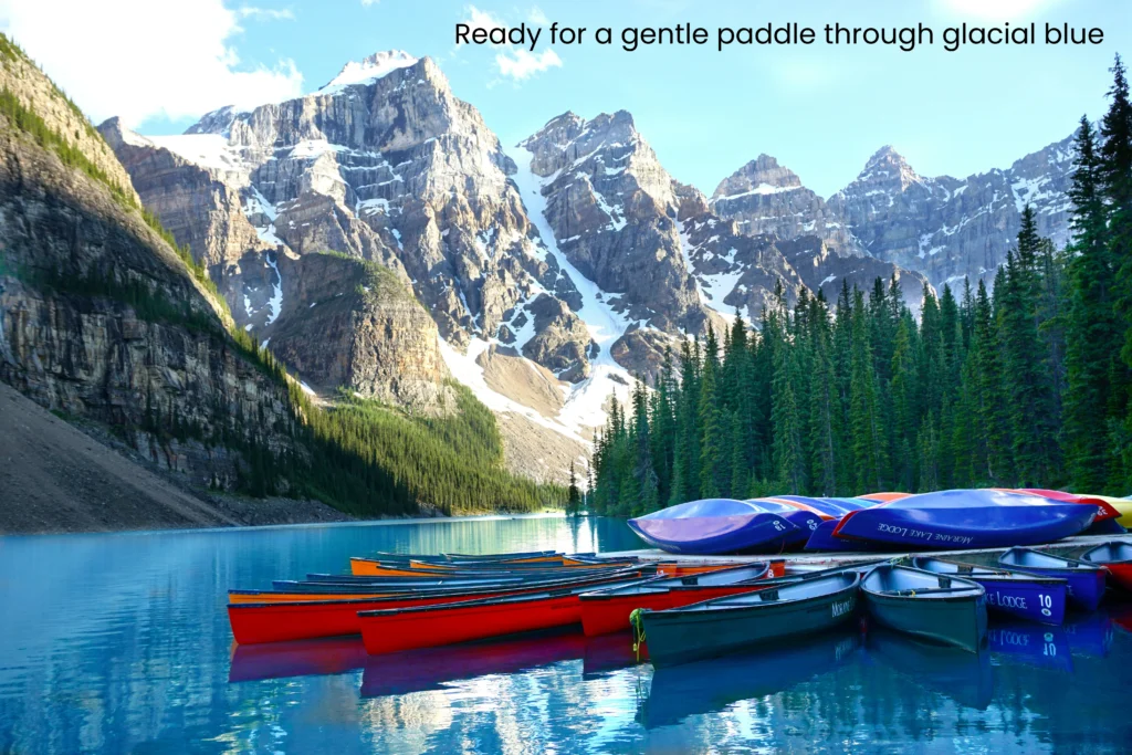 Colorful red and blue canoes lined up along a dock on the turquoise water of Moraine Lake in Banff National Park.