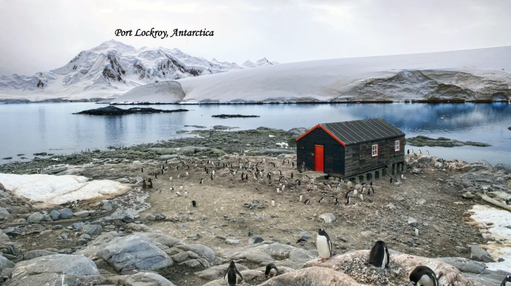 antarctica tourism Port Lockroy historic station surrounded by snowy Antarctic mountains