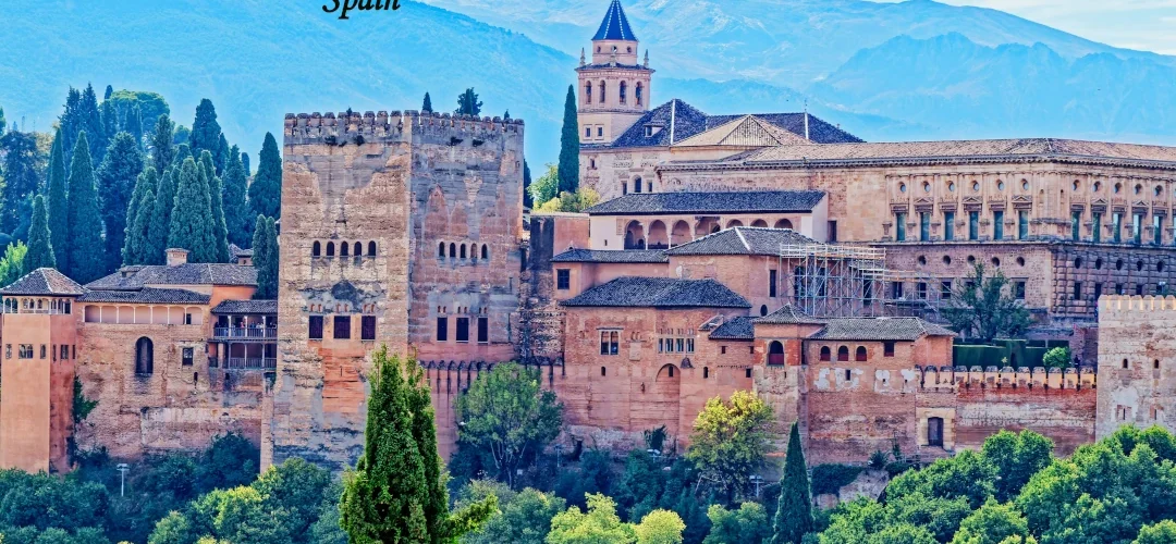 Spain Tourism Alhambra palace and historic architecture surrounded by green hills