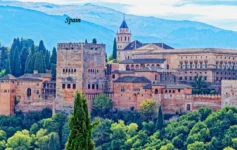 Spain Tourism Alhambra palace and historic architecture surrounded by green hills