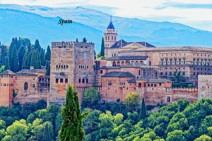 Spain Tourism Alhambra palace and historic architecture surrounded by green hills