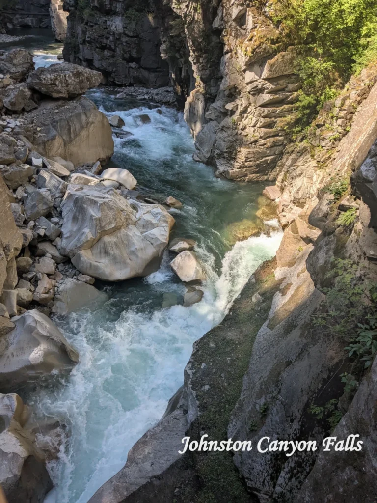 Johnston Canyon Falls is a must see on Banff National Park tours, featuring cascading waterfalls, limestone cliffs, and scenic forest trails.